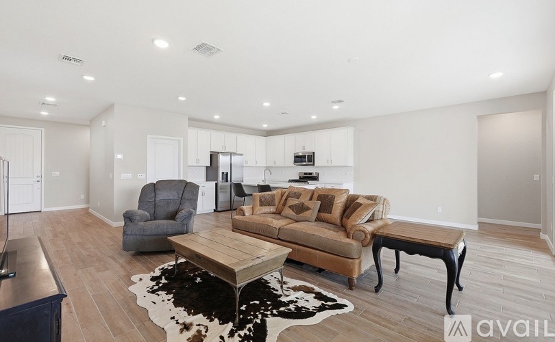 A living room with a couch, chair, and coffee table.