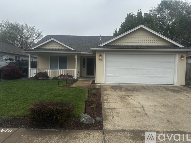 A house with a garage and a driveway in front.