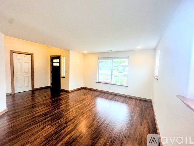 A room with wooden floors and white walls.
