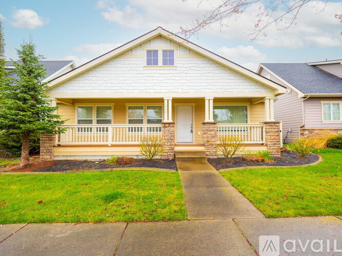 A house with a front yard and a sidewalk leading to the front door.