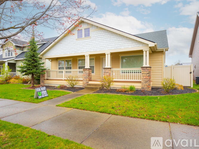 A house with a sign that says "For Sale" in front of it.
