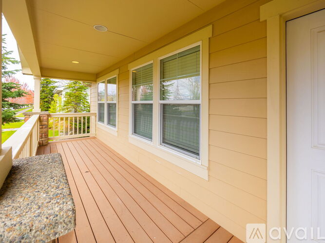 A porch with a bench and a door.