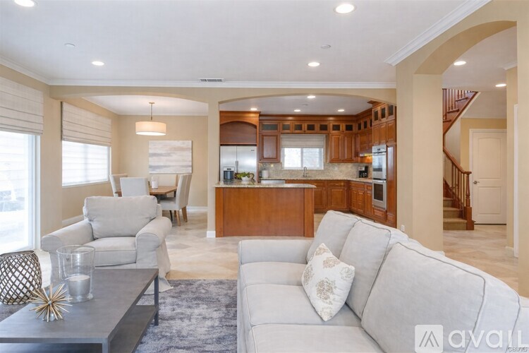 A modern living room with a grey sofa and a wooden coffee table.