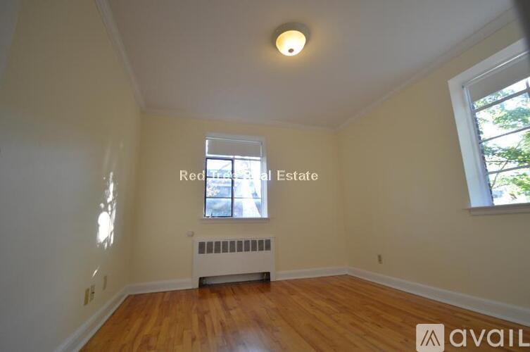 A room with a window and a radiator is available for rent.