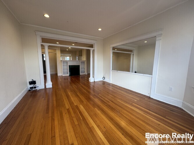 A room with wooden floors and white walls.