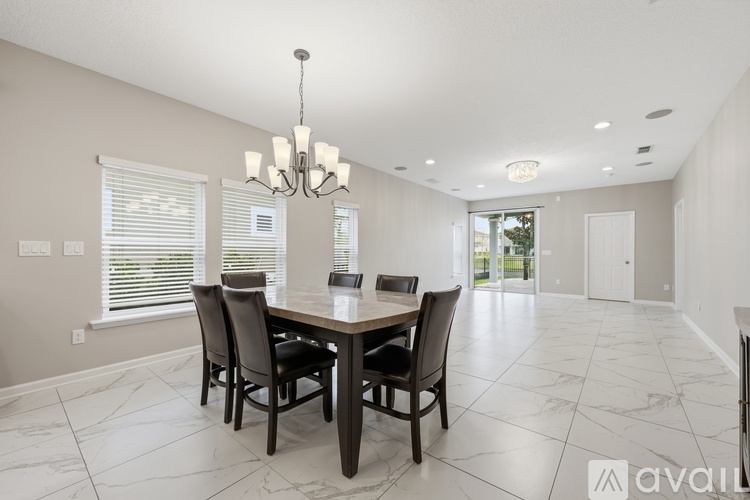 A dining room with a table and chairs.