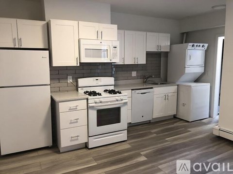 A kitchen with white appliances and cabinets.