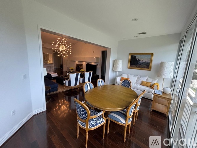 A dining room with a wooden table and chairs.