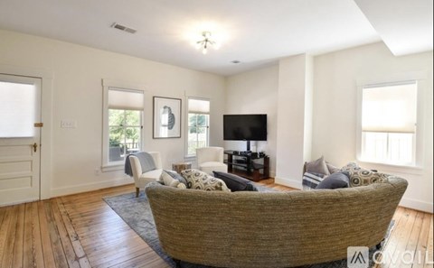 A living room with a large couch and a television.