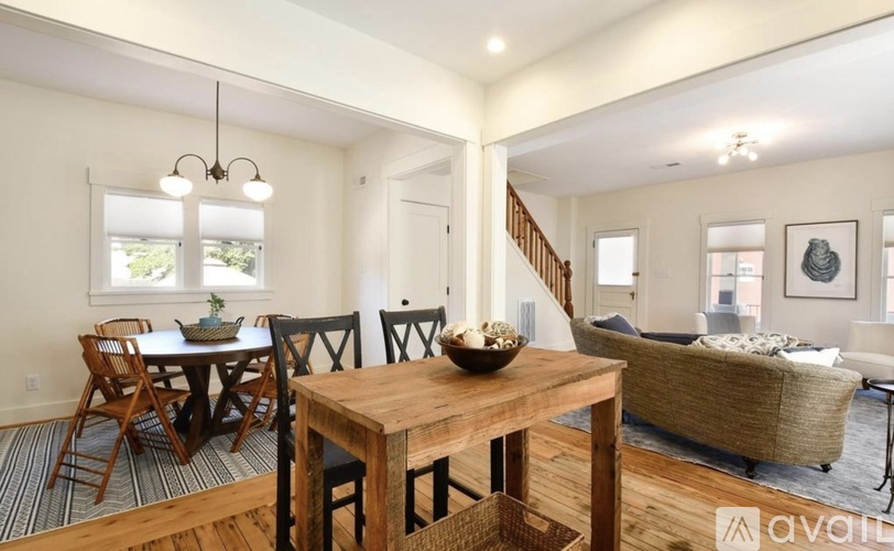 A dining room with a wooden table and chairs.