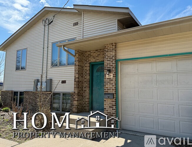A house with a garage and a sign that says "HOME PROPERTY MANAGEMENT".