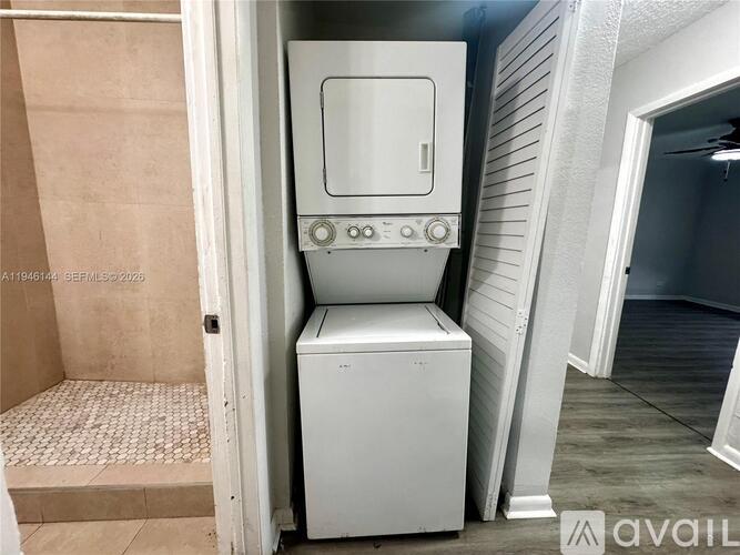 A white stove with a door is in a room.