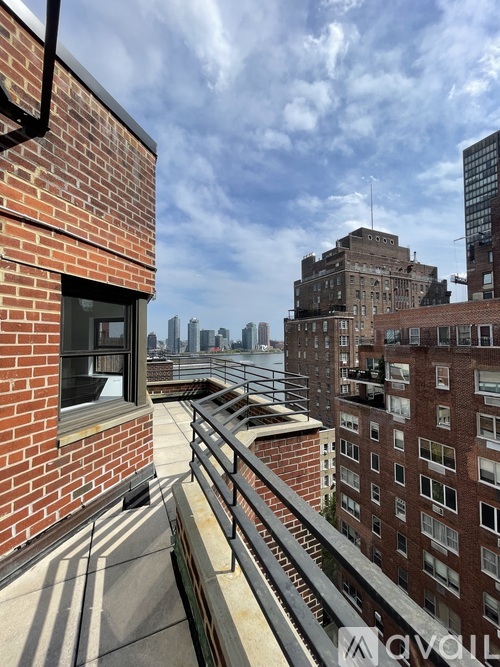A view from a balcony overlooking a cityscape.
