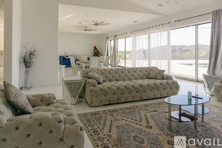 A living room with a large couch and a coffee table.