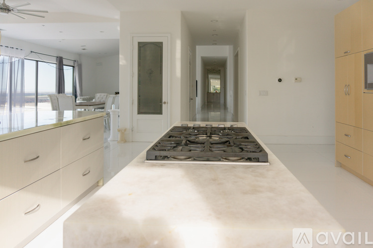A spacious room with a marble floor and a fireplace.
