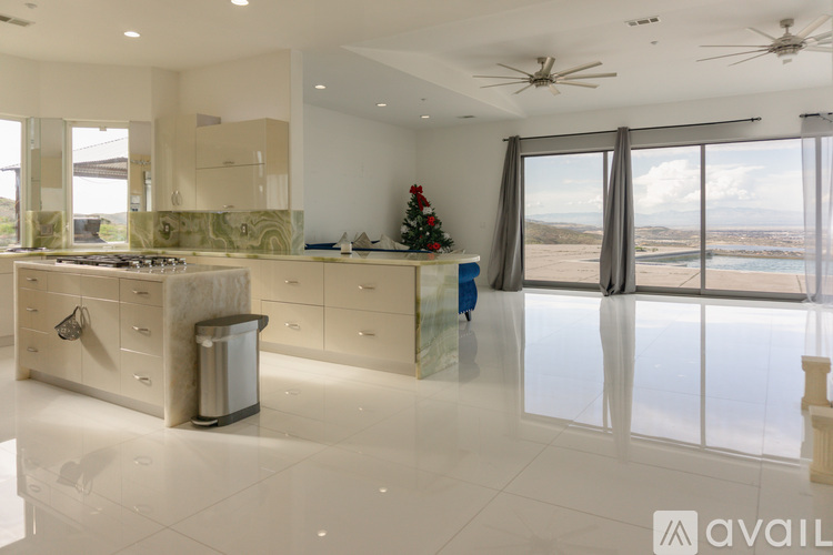 A modern kitchen with a Christmas tree in the corner.