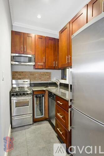 A kitchen with wooden cabinets and stainless steel appliances.