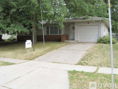 A house with a garage is for sale.