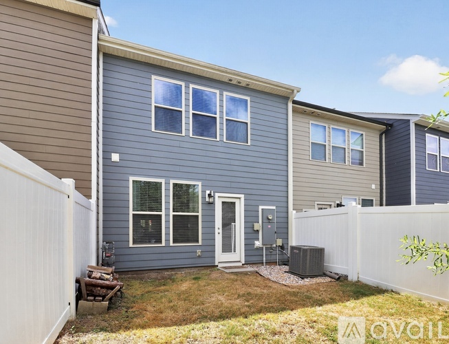 A house with a grey exterior and a white fence.