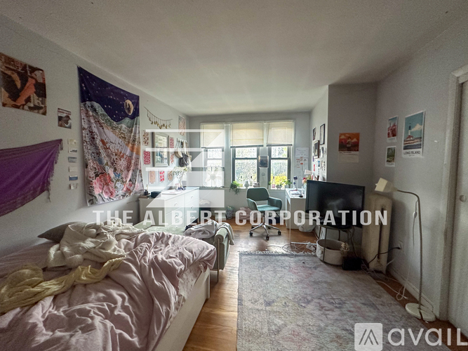 A bedroom with a bed and a poster on the wall.