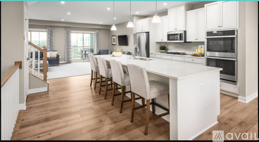 A modern kitchen with a dining table and chairs.