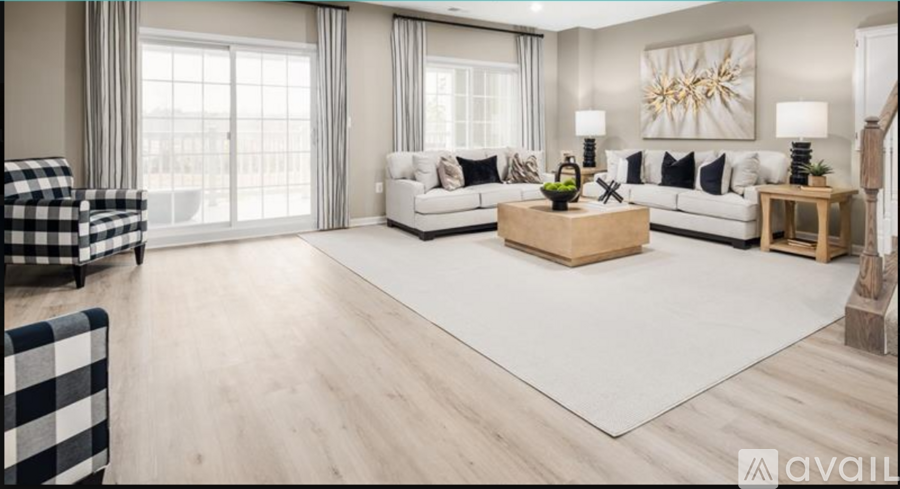 A modern living room with a checkered sofa and a wooden coffee table.