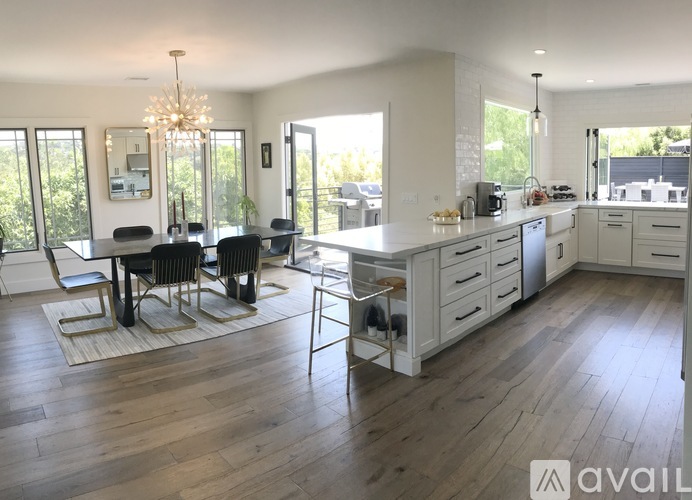 A modern kitchen with a dining table and chairs.