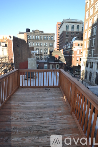 A wooden deck with a cityscape in the background.