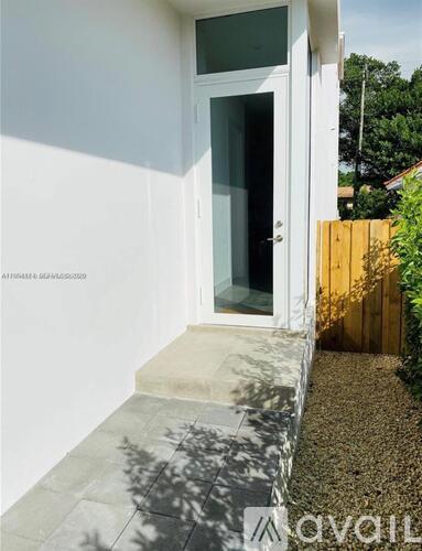A white door with a glass window is open.