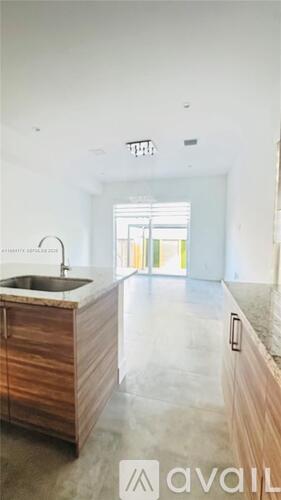 A kitchen with a sink and wooden cabinets.