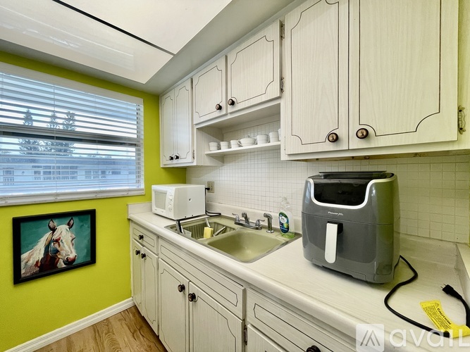 A kitchen with a toaster on the counter.