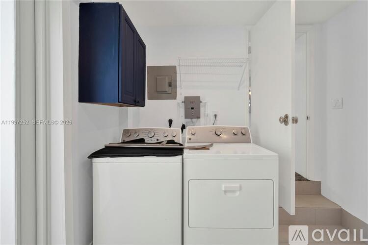 A white and black dishwasher is in a kitchen.