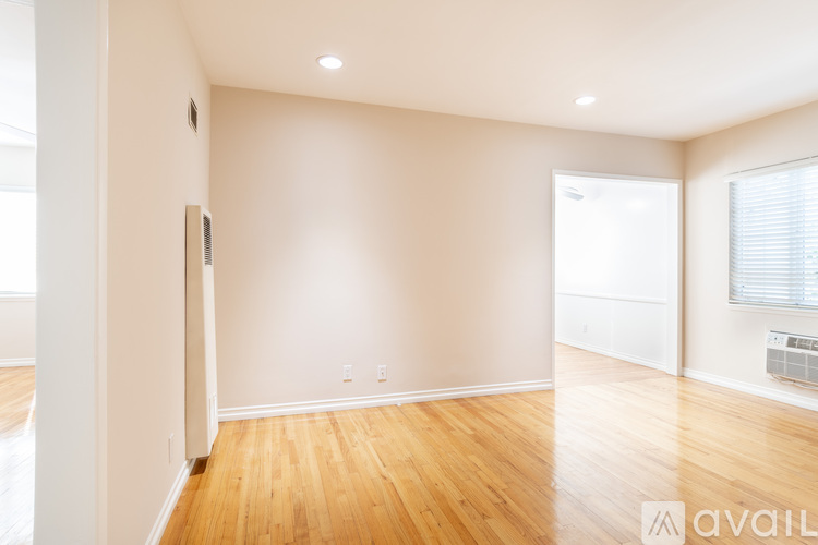 A room with wooden floors and white walls.