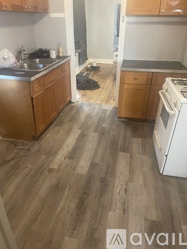 A kitchen with wooden cabinets and a white stove.