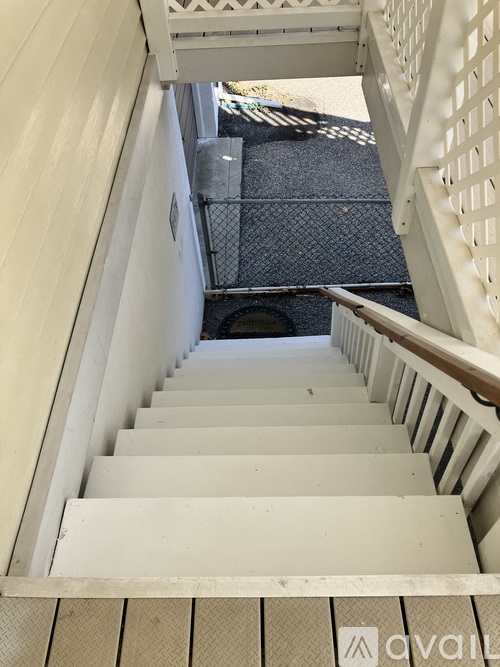 A staircase with a metal grate on the floor.