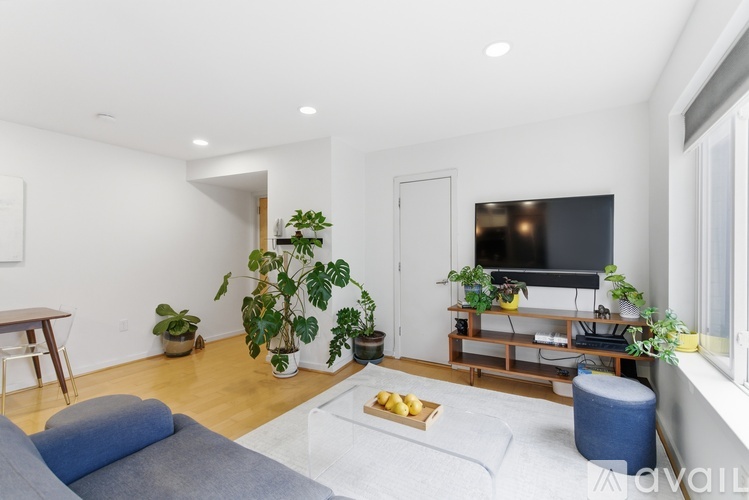 A living room with a grey sofa and a white coffee table.