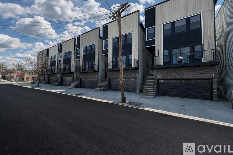 A row of modern townhouses with a clear sky above.