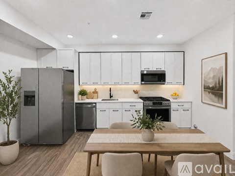 A modern kitchen with a dining table and chairs.