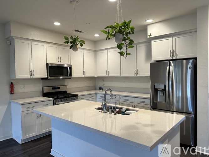 A modern kitchen with white cabinets and a large island.
