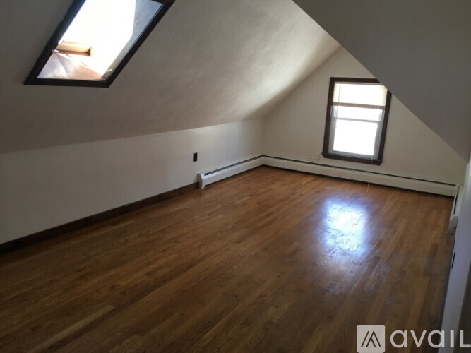 A room with wooden floors and a window.