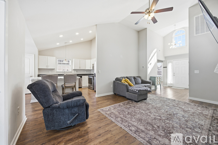 A living room with a grey sofa and a grey recliner.