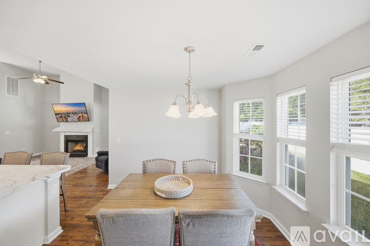 A dining room with a wooden table and chairs.