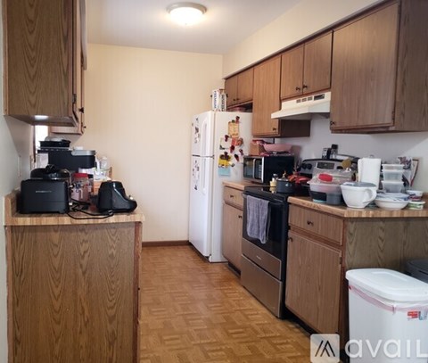 A kitchen with wooden cabinets and appliances.