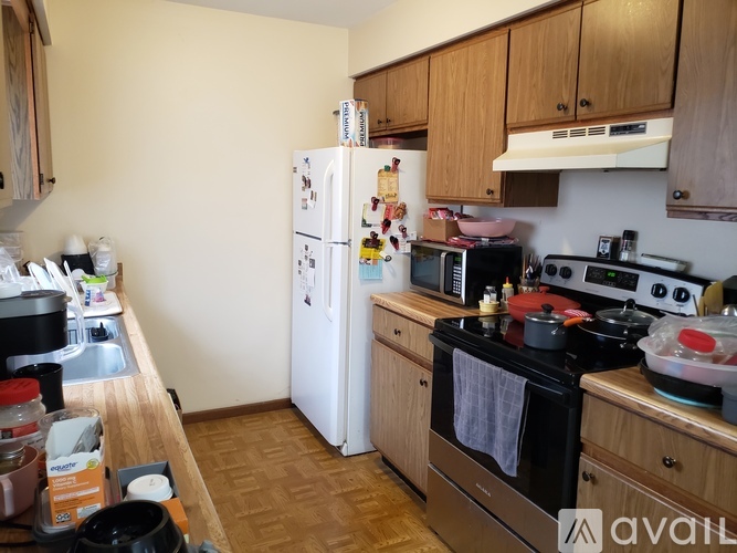 A kitchen with a white fridge and black stove.