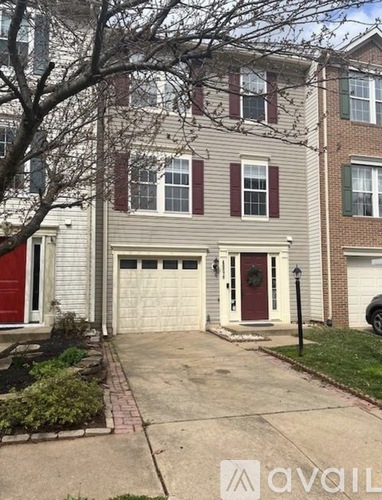 A two-story house with a red door and a garage.