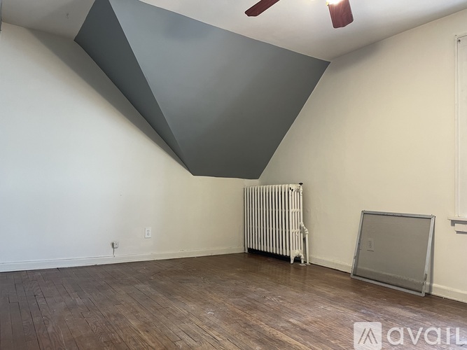 A room with a white radiator and a grey wall.