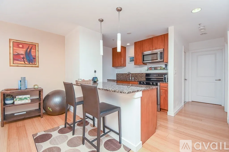 A kitchen with a white countertop and brown chairs.