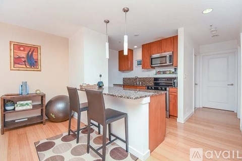 A kitchen with a white countertop and brown chairs.
