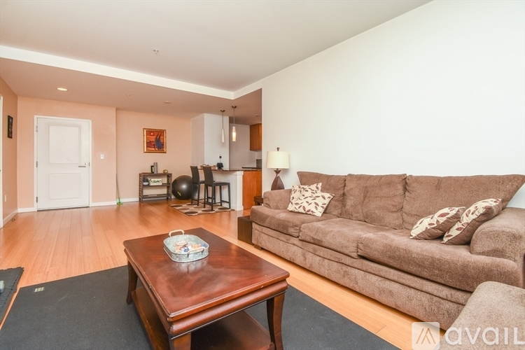 A living room with a brown couch and a wooden coffee table.