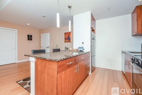 A kitchen with wooden cabinets and a granite countertop.